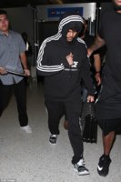 The Weeknd was pictured at LAX airport on Wednesday, wearing an Adidas tracksuit, with the hood .jpg