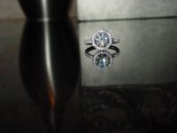 Octagonal head w floating round center stone held in signature claws. Platinum band. 170 stones tota