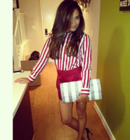Naya Rivera posed on Instagram wearing Marc Jacobs shirt, shorts and Isobel stripe clutch Credit.jpg