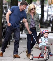 Jane Krakowski with husband Robert Godley on June 8 as they helped their son Bennett on his tric.jpg