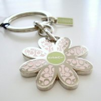 1703 coach enamel daisy keychain.jpeg