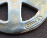 Charm-prob fake stamp on Peace necklace.jpg