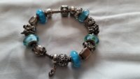 pandora beach theme with blue muranos and blue topaz.jpg