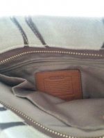 INSIDE OF THE COACH BAG HAS A LETHER TAG.jpg