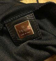 Not sure if this is the right sub for this but I need help with how to  clean off this sticky residue off of a vintage fendi bag. I'm not sure what