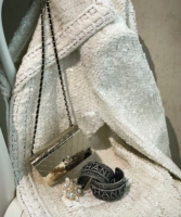 gold toned metal clutch with chain and wrist cuffs.png