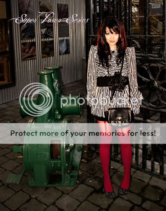 Watermarked-Vintage-dress-and-red-suspender-tights-wide-flower-belt-rocket-dog-polkadot-shoes-and-prada-cross-body-bag-by-gate.jpg